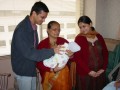 YogeshFamilyWithKaumudi Yogesh, aunty, Dhruthi looking at the newborn